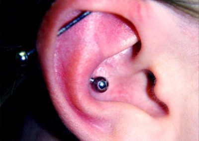 image of a woman with ear piercing done by Monte Vogel at Skin Deep