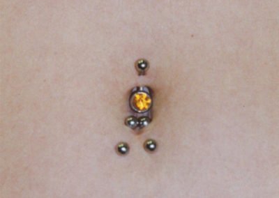 image of a belly button piercings done by Monte Vogel at Skin Deep