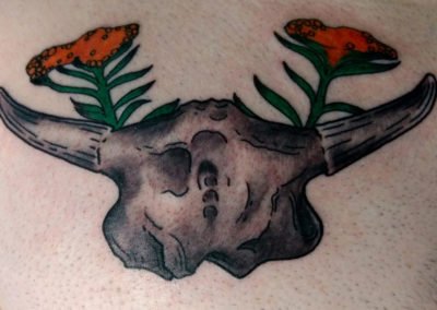 image of skull and flowers tattoo done by Mike Welch of Skin Deep